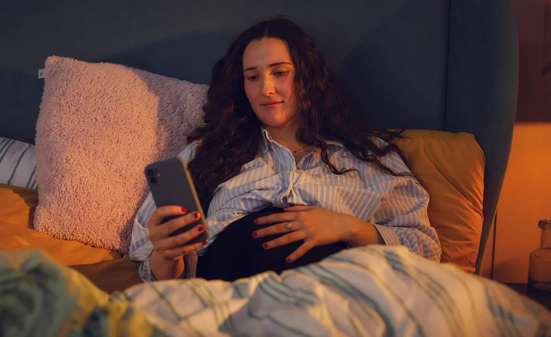 pregnant woman looking at mobile phone