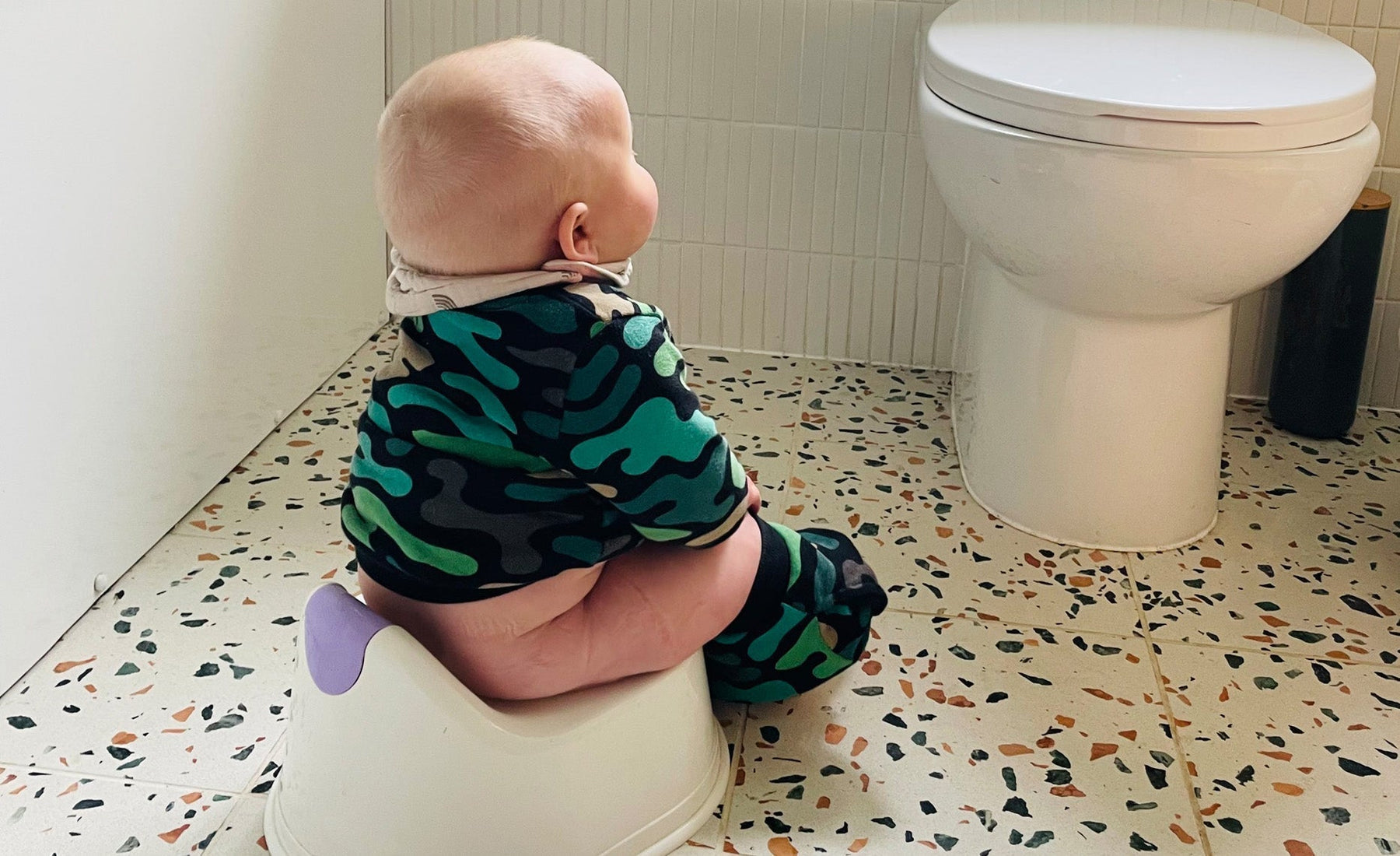 Baby being held over a potty