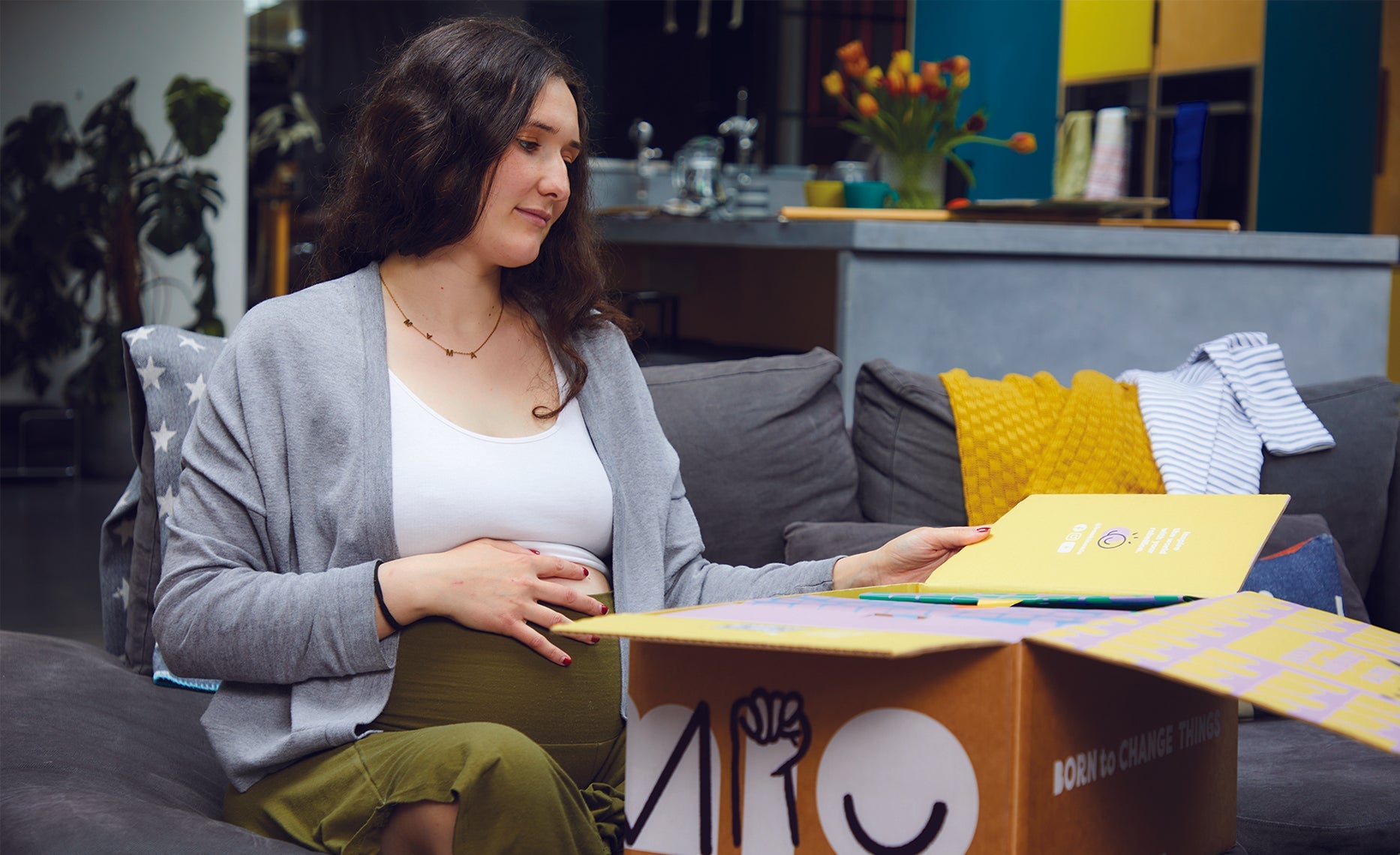 pregnant woman watching her baby shower gifts